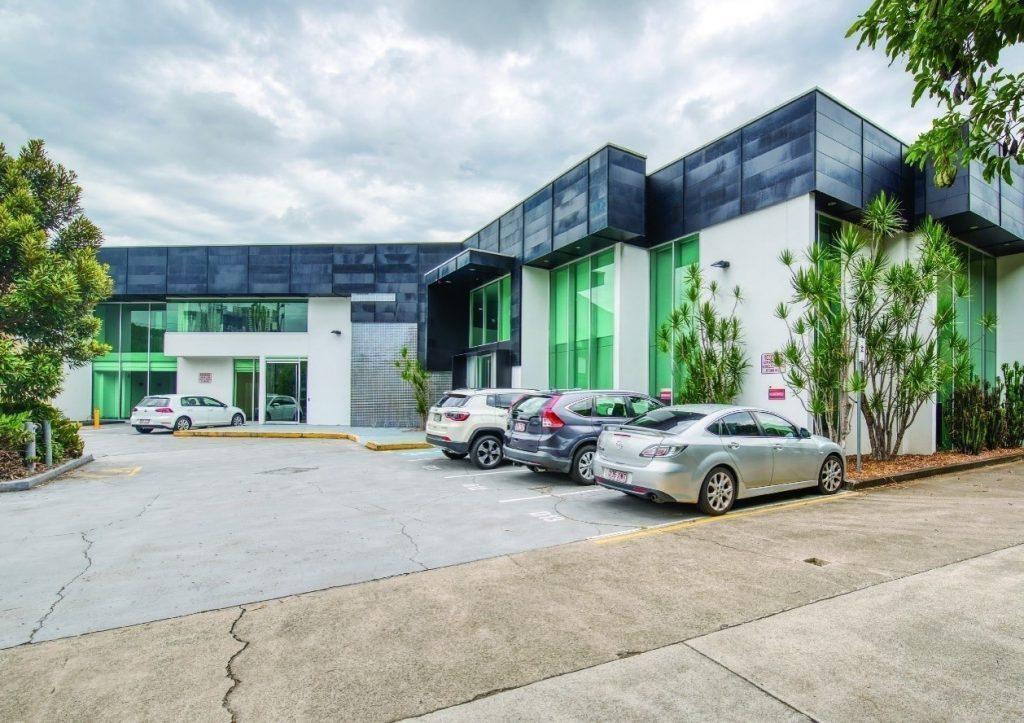 a modern two-storey medical asset with large glass windows and a clean, sleek exterior.